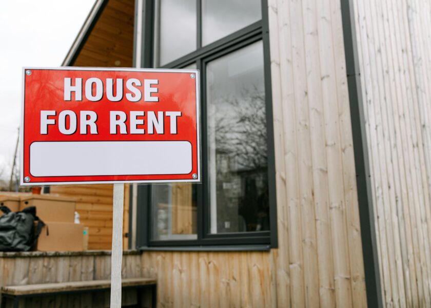 Red House for rent sign in front of Property